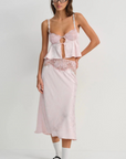 Pink satin sleep lingerie top
Open-front satin cami tank top
Sleek floral jacquard,
Adorned with lace trims, decorative bows, and a rosette at the center-front
Adjustable shoulder straps
Hook and eye closure at center-back
Unlined
Polyester/Elastane