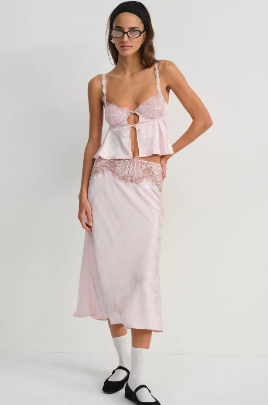 Pink satin sleep lingerie top
Open-front satin cami tank top
Sleek floral jacquard,
Adorned with lace trims, decorative bows, and a rosette at the center-front
Adjustable shoulder straps
Hook and eye closure at center-back
Unlined
Polyester/Elastane