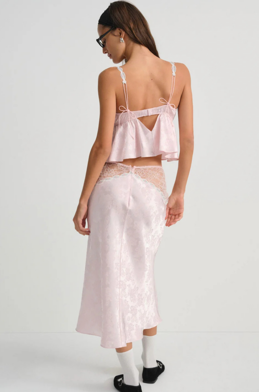 Pink satin sleep lingerie top
Open-front satin cami tank top
Sleek floral jacquard,
Adorned with lace trims, decorative bows, and a rosette at the center-front
Adjustable shoulder straps
Hook and eye closure at center-back
Unlined
Polyester/Elastane
