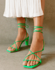 Newly designed in an electrifying neon shade. Inspired by a classic feminine silhouette, the Bellini sandals represent the ultimate combination of glamour and comfort. Crafted in soft leather, this lace-up style wraps around the ankle in a barely there delicate sandal that is perfect for any special occasion. green strappy heel