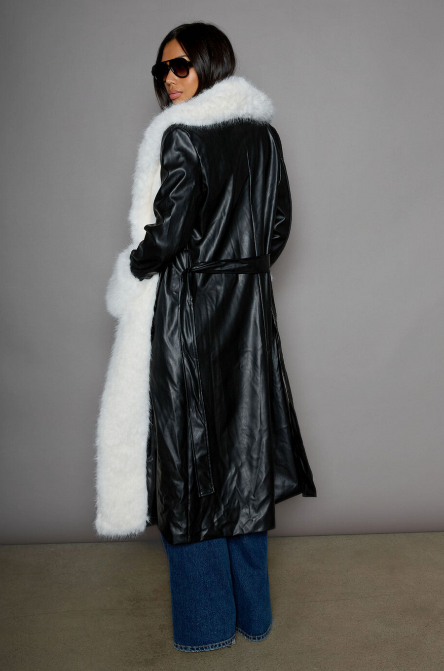 Faux leather longline coat. Faux fur trim. Collar neckline. Long sleeves. Open front. Tie waist. Fully lined. black leather coat. fur coat. coat for winter. cute leather coat. fashionable leather coat