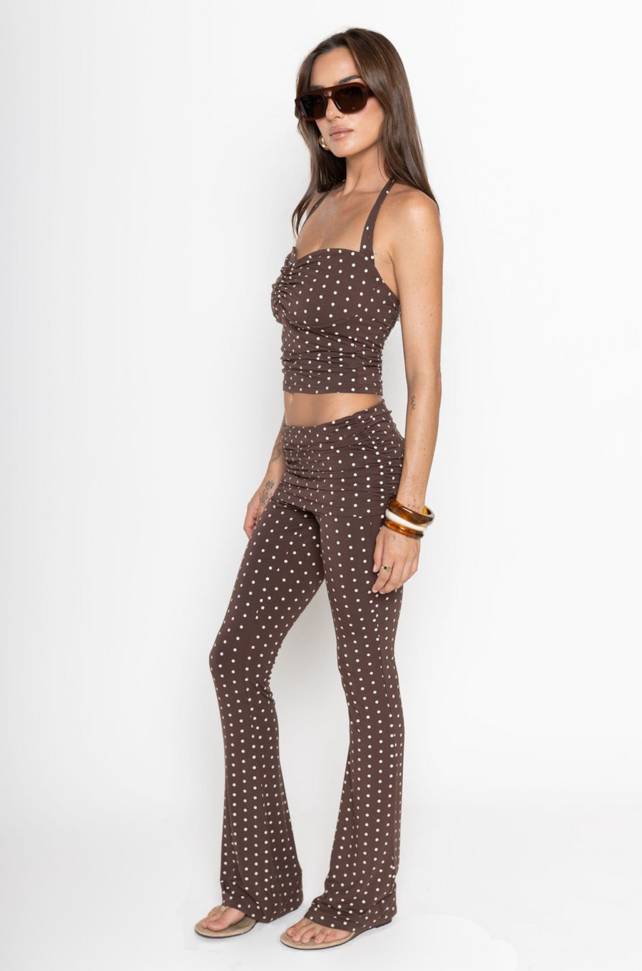 TOP

Polka dot halter top
Adjustable tie top
Ruched bust
Unlined
Length: 19"
Rayon/Spandex
BOTTOM

Polka dot pant
Fold over
Ruched sides
Flare bottom
Rayon/Spandex
Length: 39"
Runs small
brown polka dot tank top and pant set
