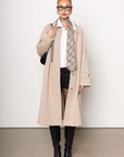 beige Longline trench coat
Pointed collar
Raglan sleeves
Welt pockets
Back slit
Midi-length
Button down closure