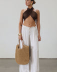Woven straw bag. Vegan leather top handles. Top zipper closure. Fully lined. Inner pockets. Beach bag.