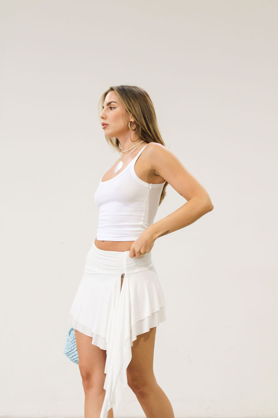 Knit skirt. Elastic waist. Ruched waist. Asymmetric hem. Unlined. White skirt