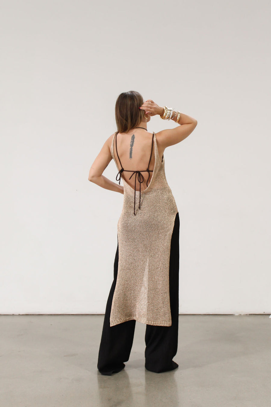 Metallic open knit crochet maxi dress. Fixed straps. Side slits. Low back. Unlined.