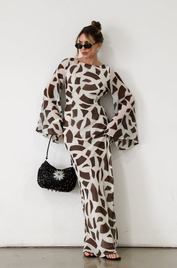 Printed chiffon maxi dress. Long bell sleeves. Adjustable crisscross back straps. Side slit. Fully lined. Dinner dress. Classy dinner dress. Fancy dinner dress. Nice dinner dress. Dressed up vacation outfits. Dress to wear on vacation. Nice dress to wear on vacation. Open back dress