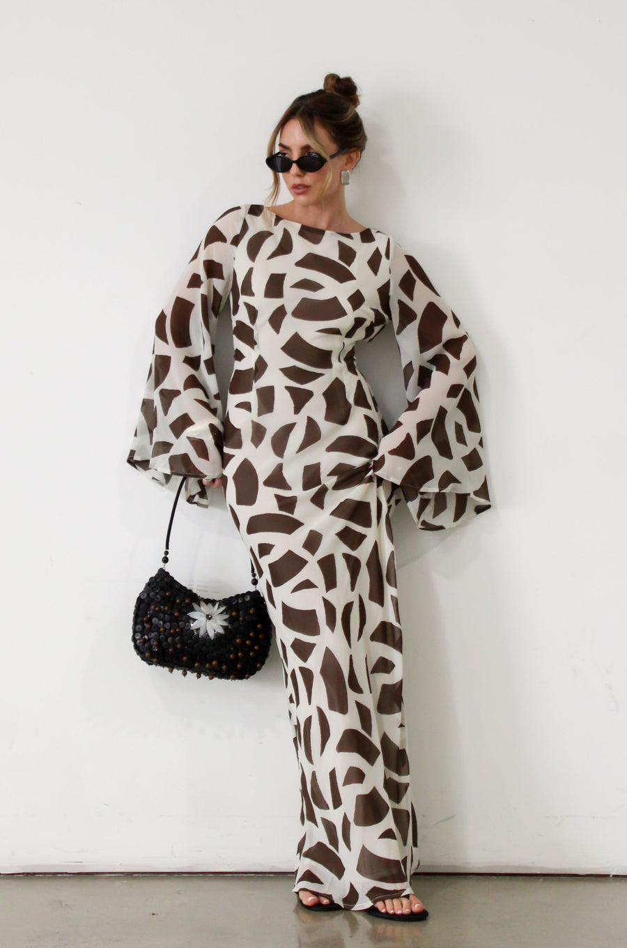 Printed chiffon maxi dress. Long bell sleeves. Adjustable crisscross back straps. Side slit. Fully lined. Dinner dress. Classy dinner dress. Fancy dinner dress. Nice dinner dress. Dressed up vacation outfits. Dress to wear on vacation. Nice dress to wear on vacation. Open back dress