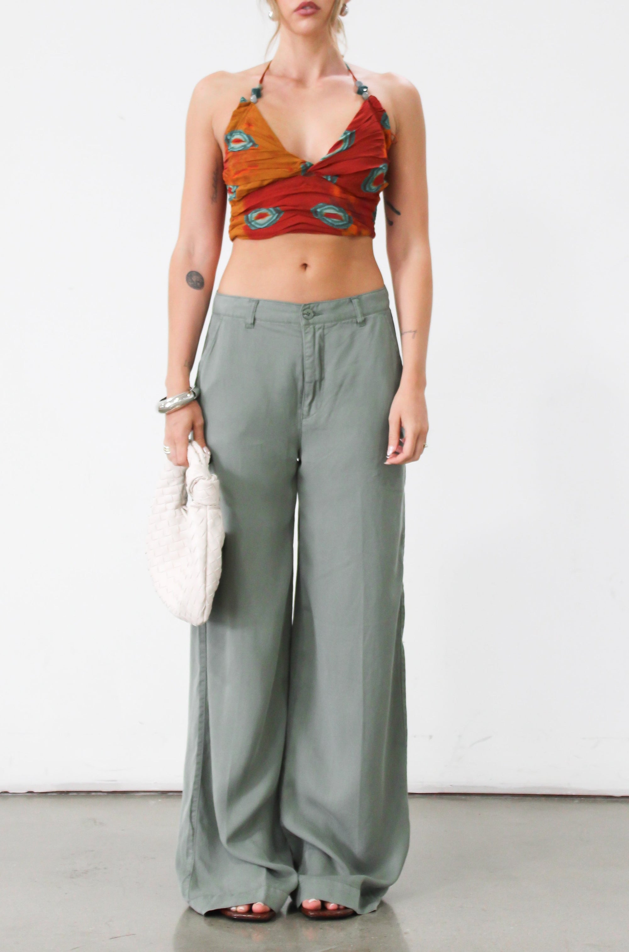 Woven wide leg pants. Low slung palazzo pant. No stretch. Button and zipper fly. Side pockets. Faux back pockets. Unlined. Green pants. Green trousers. Olive trousers. Business casual pants