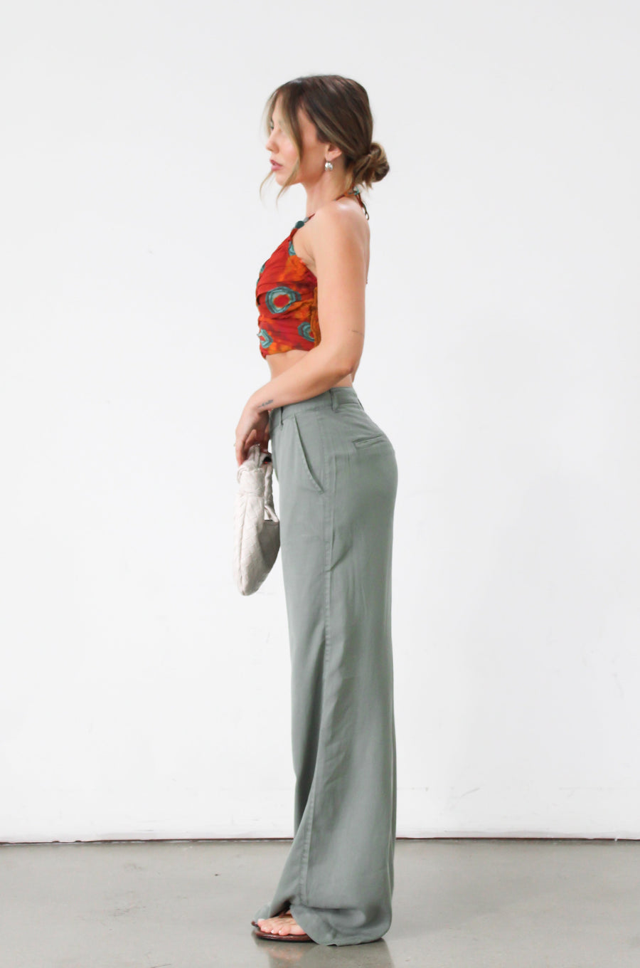 Woven wide leg pants. Low slung palazzo pant. No stretch. Button and zipper fly. Side pockets. Faux back pockets. Unlined. Green pants. Green trousers. Olive trousers. Business casual pants