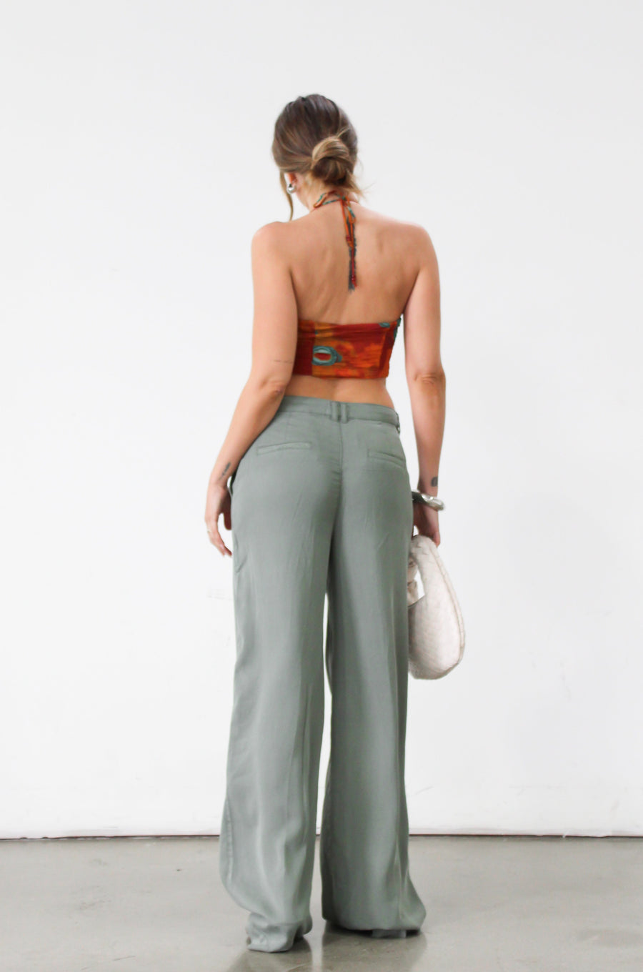 Woven wide leg pants. Low slung palazzo pant. No stretch. Button and zipper fly. Side pockets. Faux back pockets. Unlined. Green pants. Green trousers. Olive trousers. Business casual pants