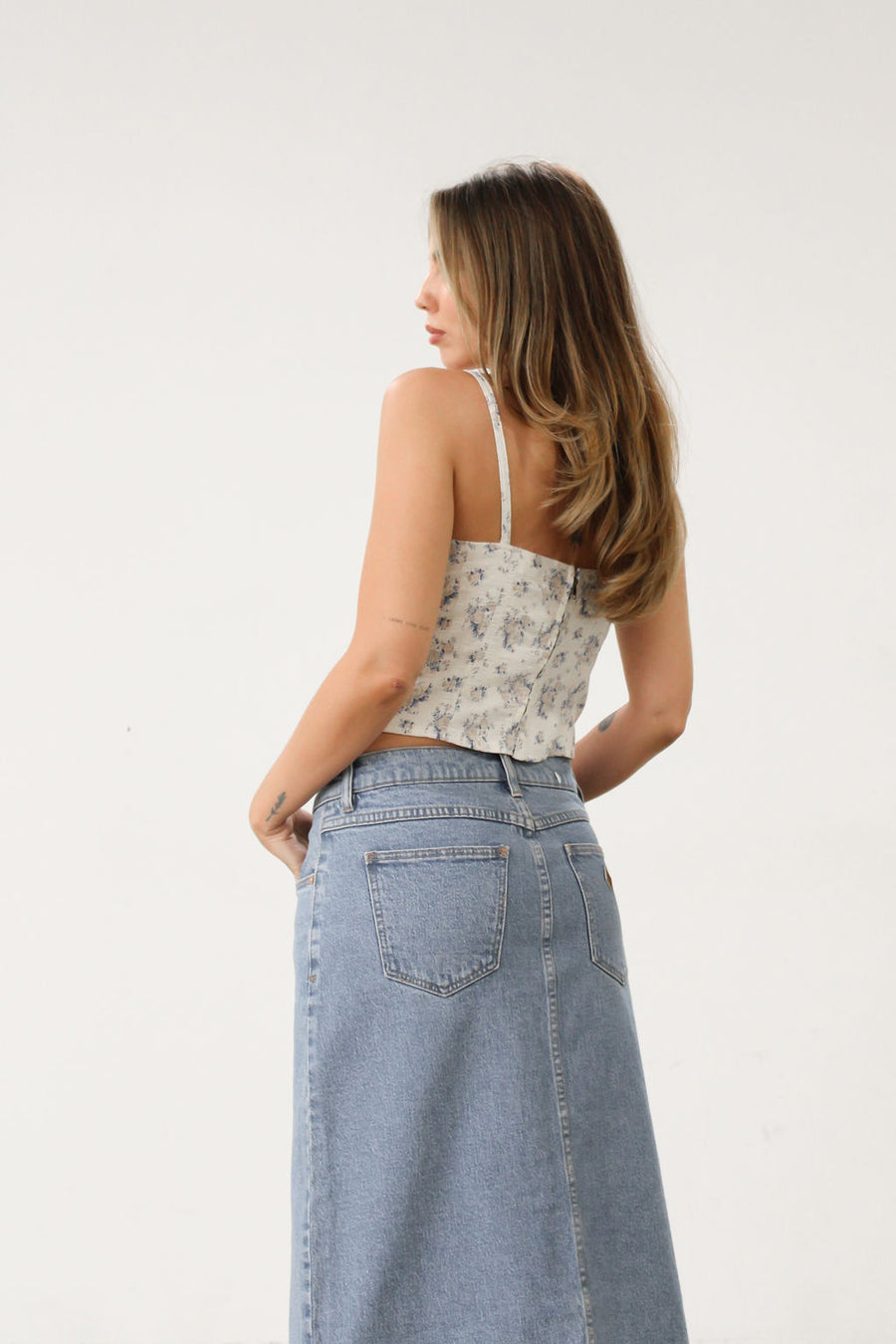 Floral printed woven bustier top. Fixed straps. Back hook and eye and zipper closures. Fully lined. White with blue floral top. Corset top.
