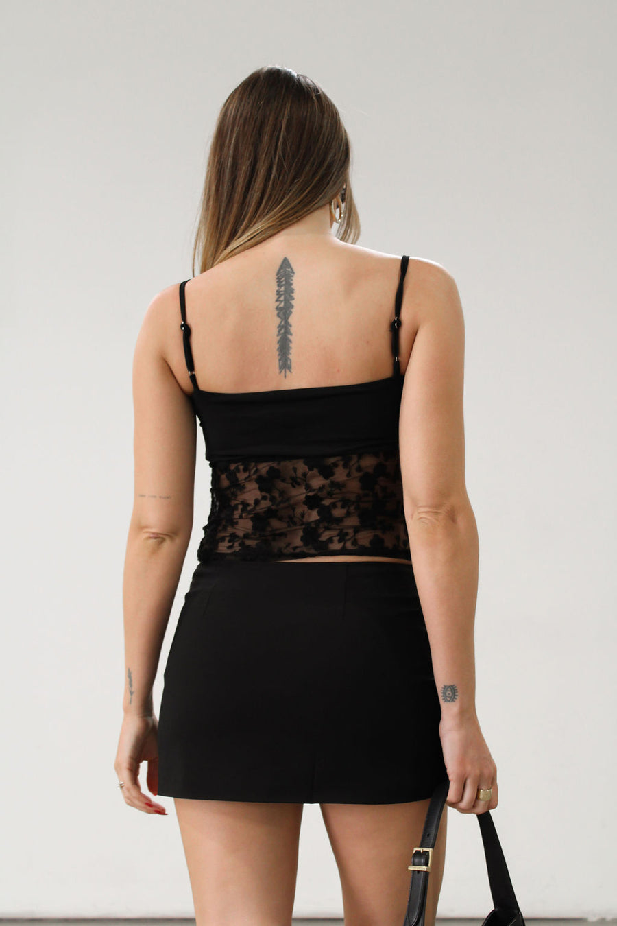 Knit and lace crop tank top. Adjustable straps. Partially lined.