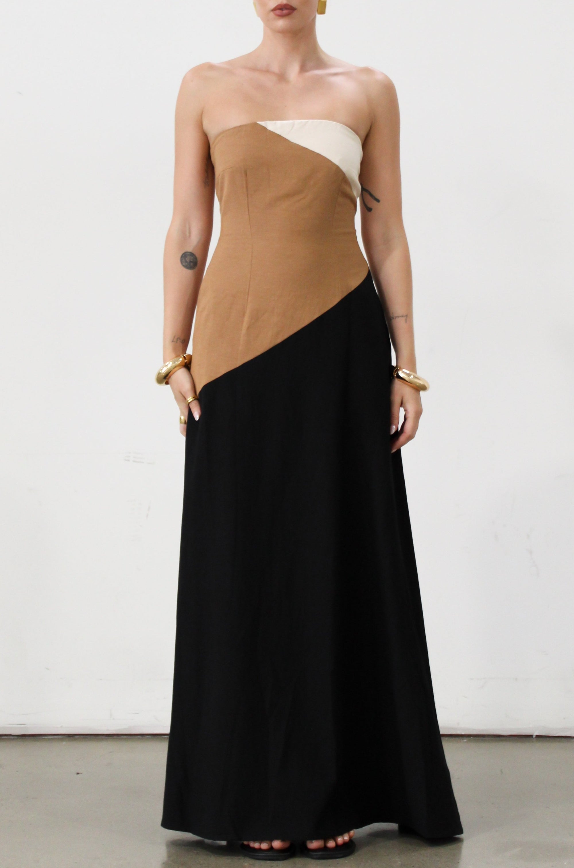 Colorblock woven maxi dress. Strapless neckline. Inner rubber grip lining. Back hook and eye and zipper closures. Fully lined. brown maxi dress. 