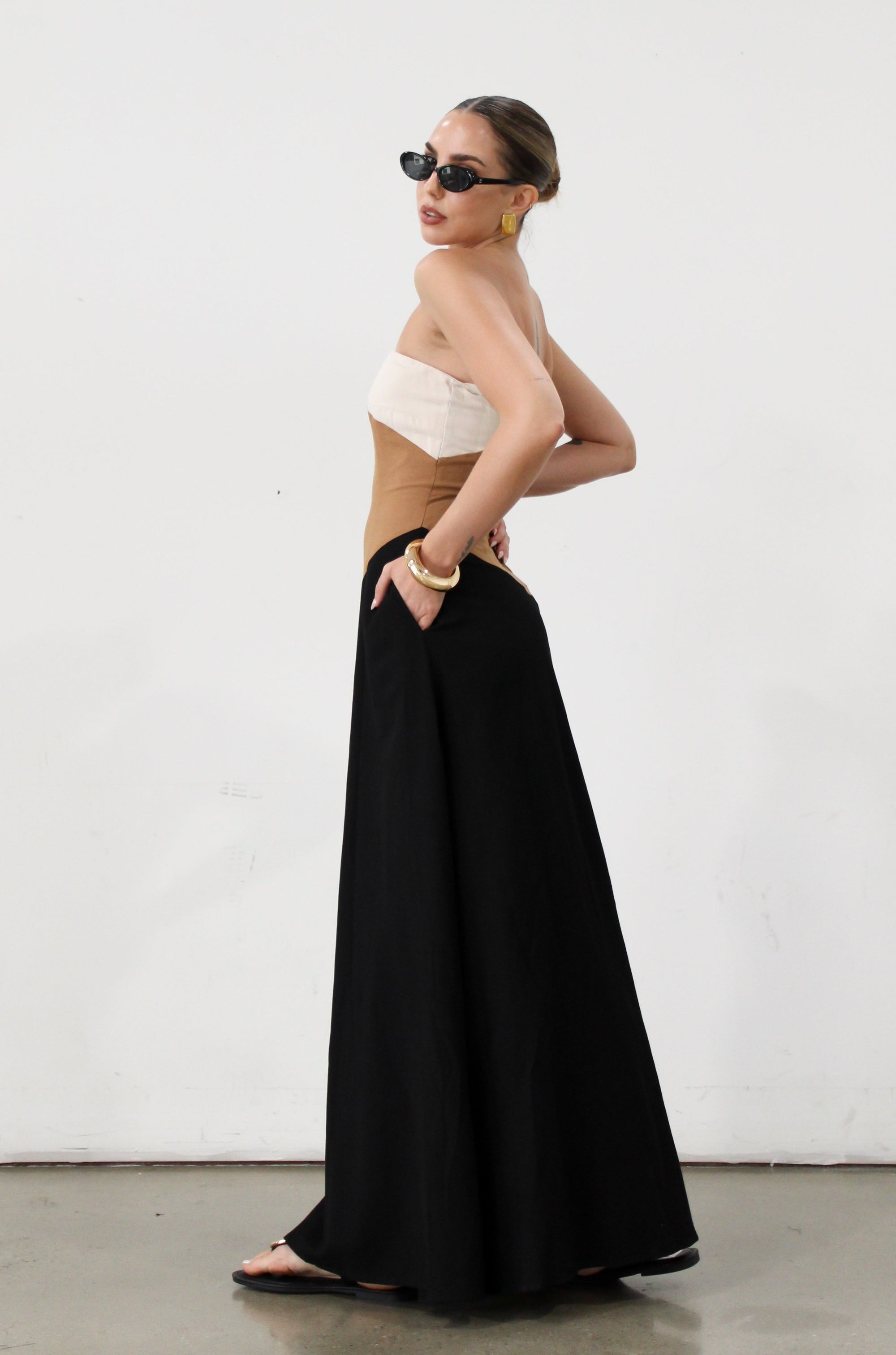 Colorblock woven maxi dress. Strapless neckline. Inner rubber grip lining. Back hook and eye and zipper closures. Fully lined. brown maxi dress. 