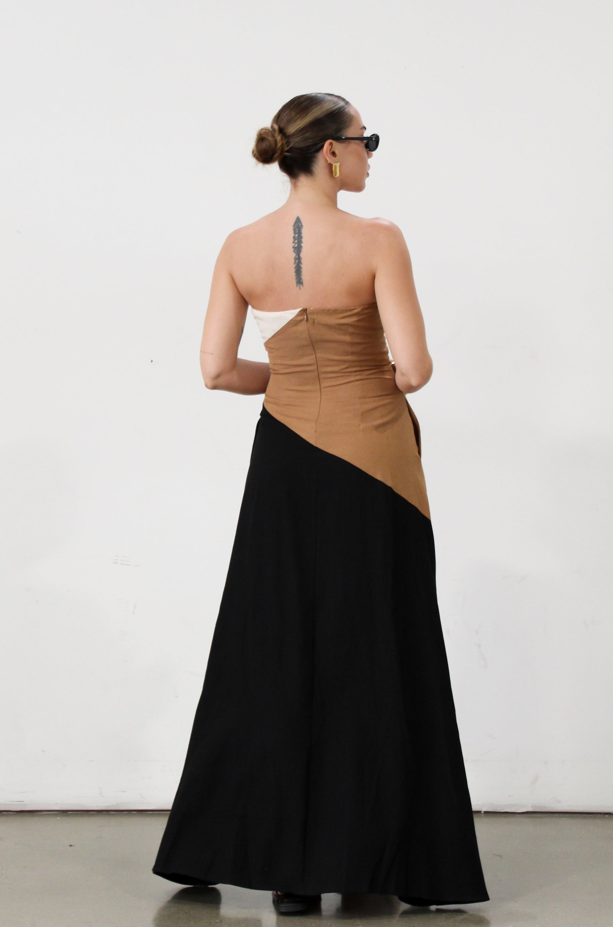 Colorblock woven maxi dress. Strapless neckline. Inner rubber grip lining. Back hook and eye and zipper closures. Fully lined. brown maxi dress. 