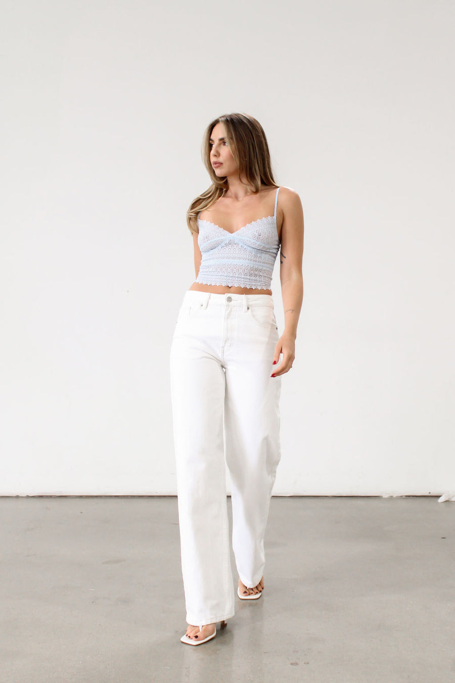 Knit lace cropped tank top. Elastic straps. Elastic back neckline. Ribbed knit back panel. Unlined. Baby blue lace tank top.