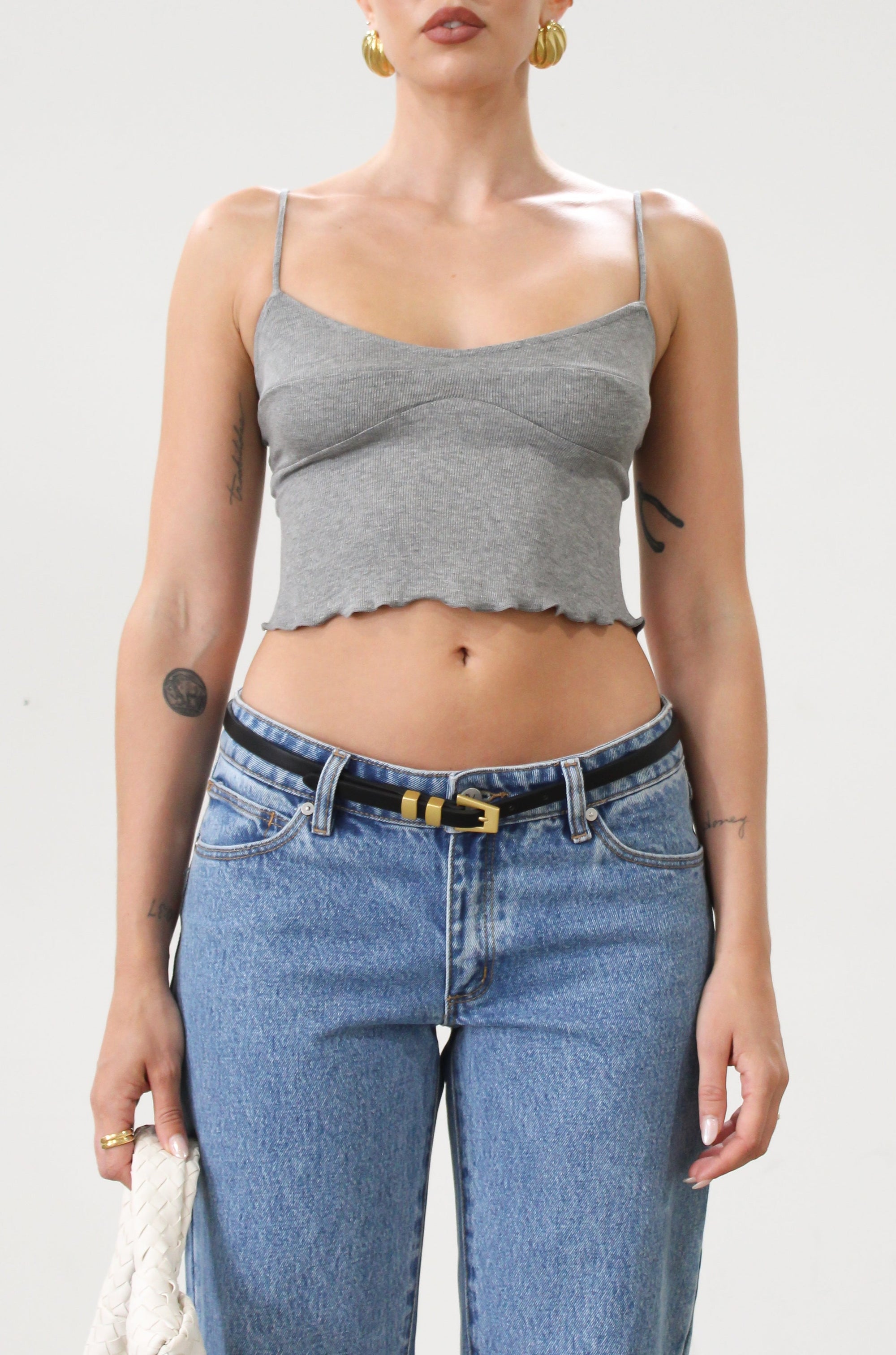 Ribbed knit cropped tank top. Adjustable straps. Lettuce edge hem. Unlined. basic crop top. basic tank top. basic grey tank top. grey tank top. grey crop tank top. everyday tank top