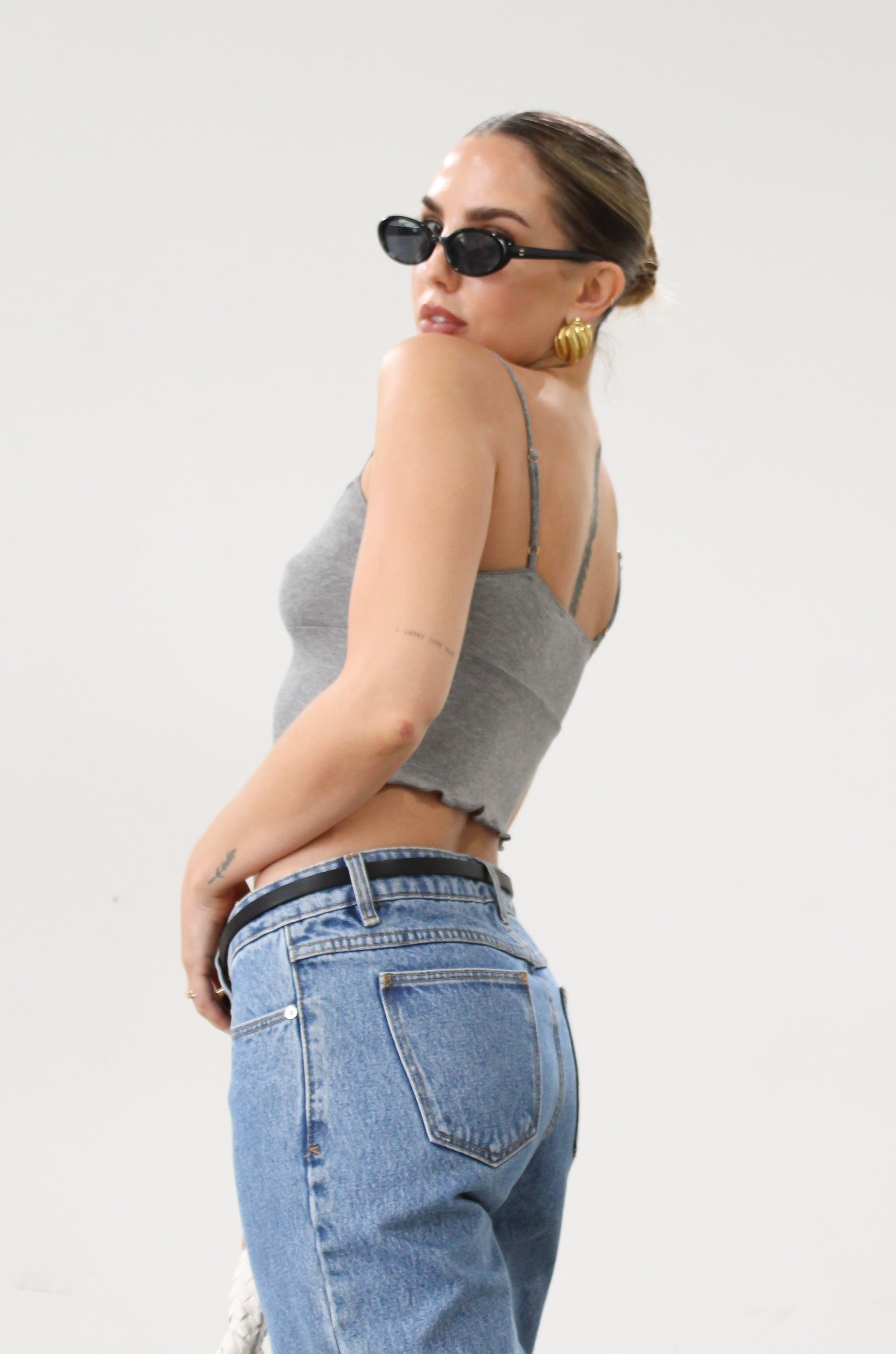 Ribbed knit cropped tank top. Adjustable straps. Lettuce edge hem. Unlined. basic crop top. basic tank top. basic grey tank top. grey tank top. grey crop tank top. everyday tank top