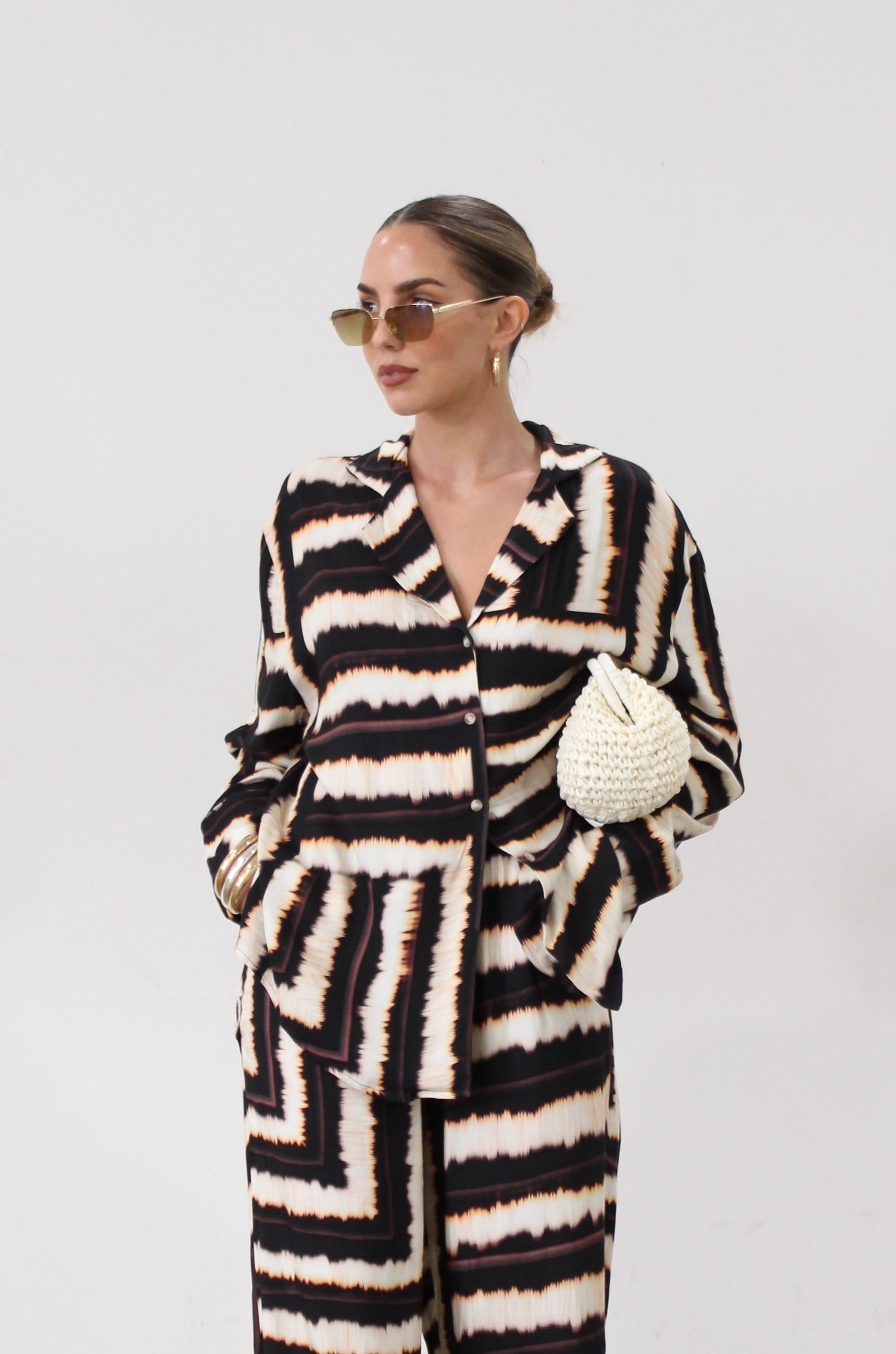 Printed woven shirt. Collar neckline. Long sleeves. Front button down closures. Side slits. Unlined. matching set. lounge set. throw on set. set for vacation.