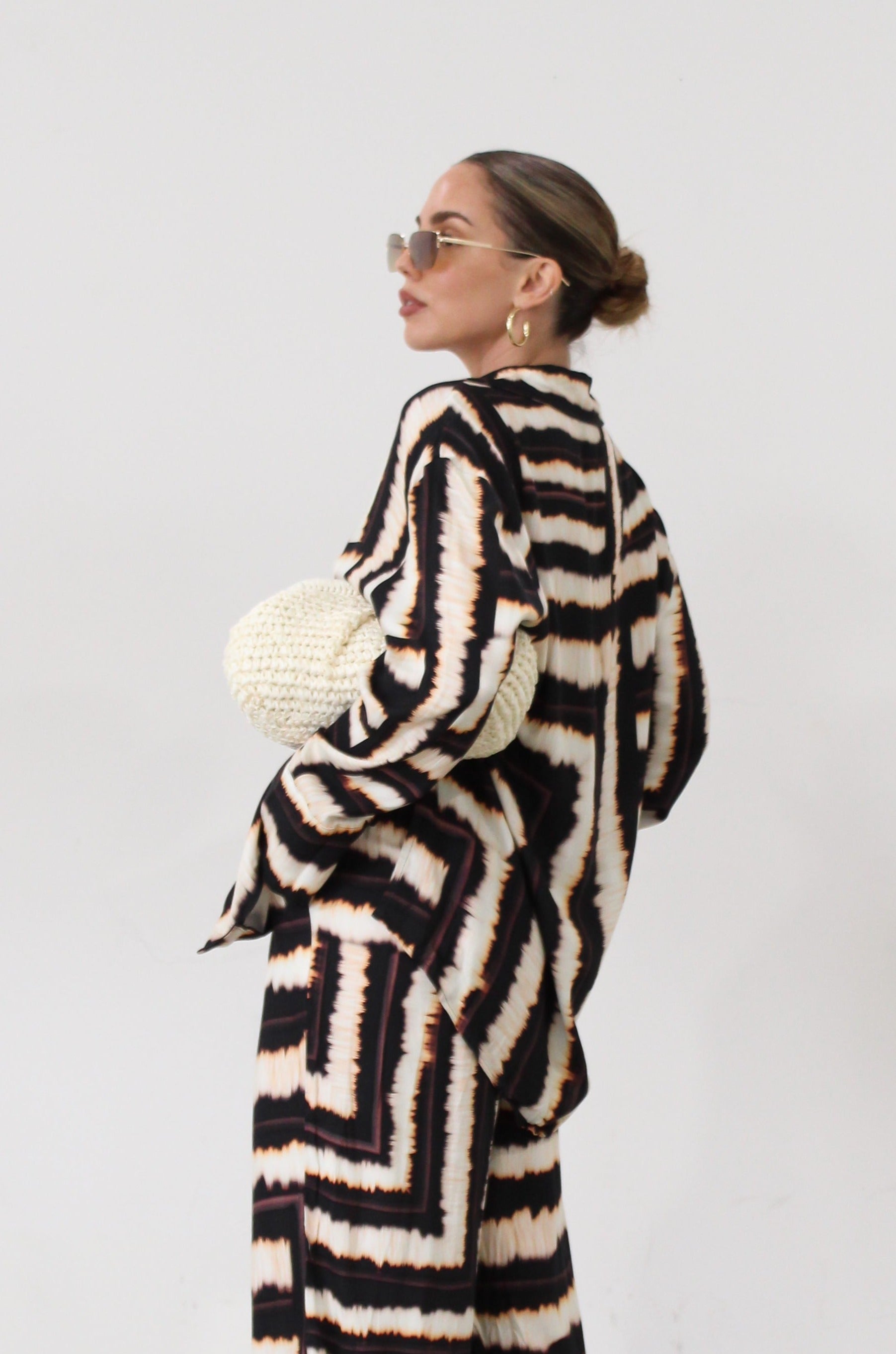 Printed woven shirt. Collar neckline. Long sleeves. Front button down closures. Side slits. Unlined. matching set. lounge set. throw on set. set for vacation.