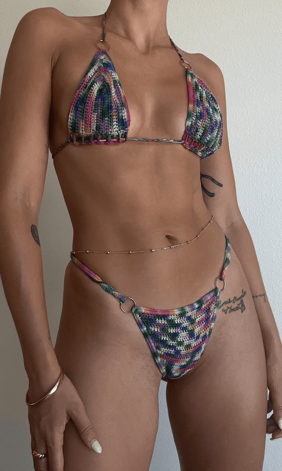 Tie dye crochet knit triangle bikini top. Ring details. Adjustable back tie closures with tassel details. Unlined. Bikini top. Crochet swimsuit 