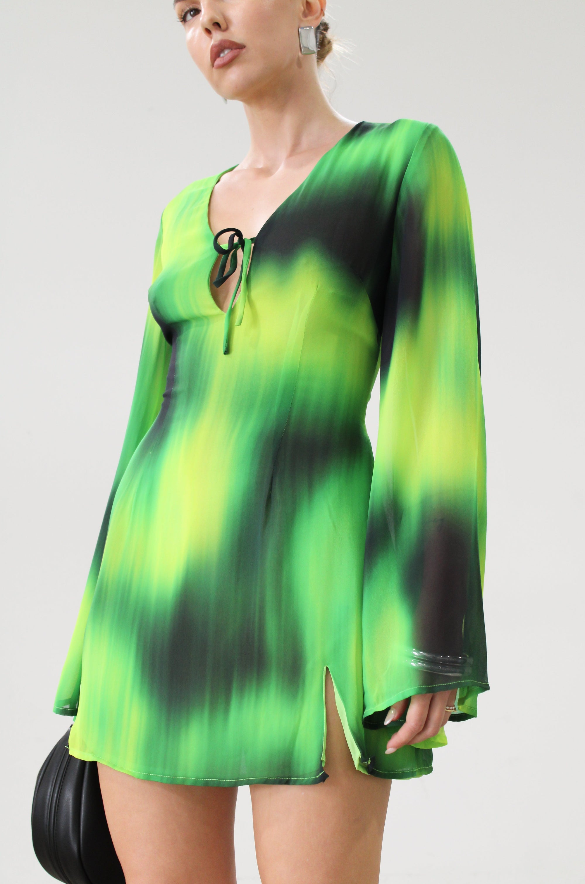 Chiffon dress. Long bell sleeves. V-neckline with tie closure. Front slit. Back hook and eye and zipper closures. Partially lined. green dress. beach vacation dress. green mini dress. mexico dress. miami dress. going out dress
