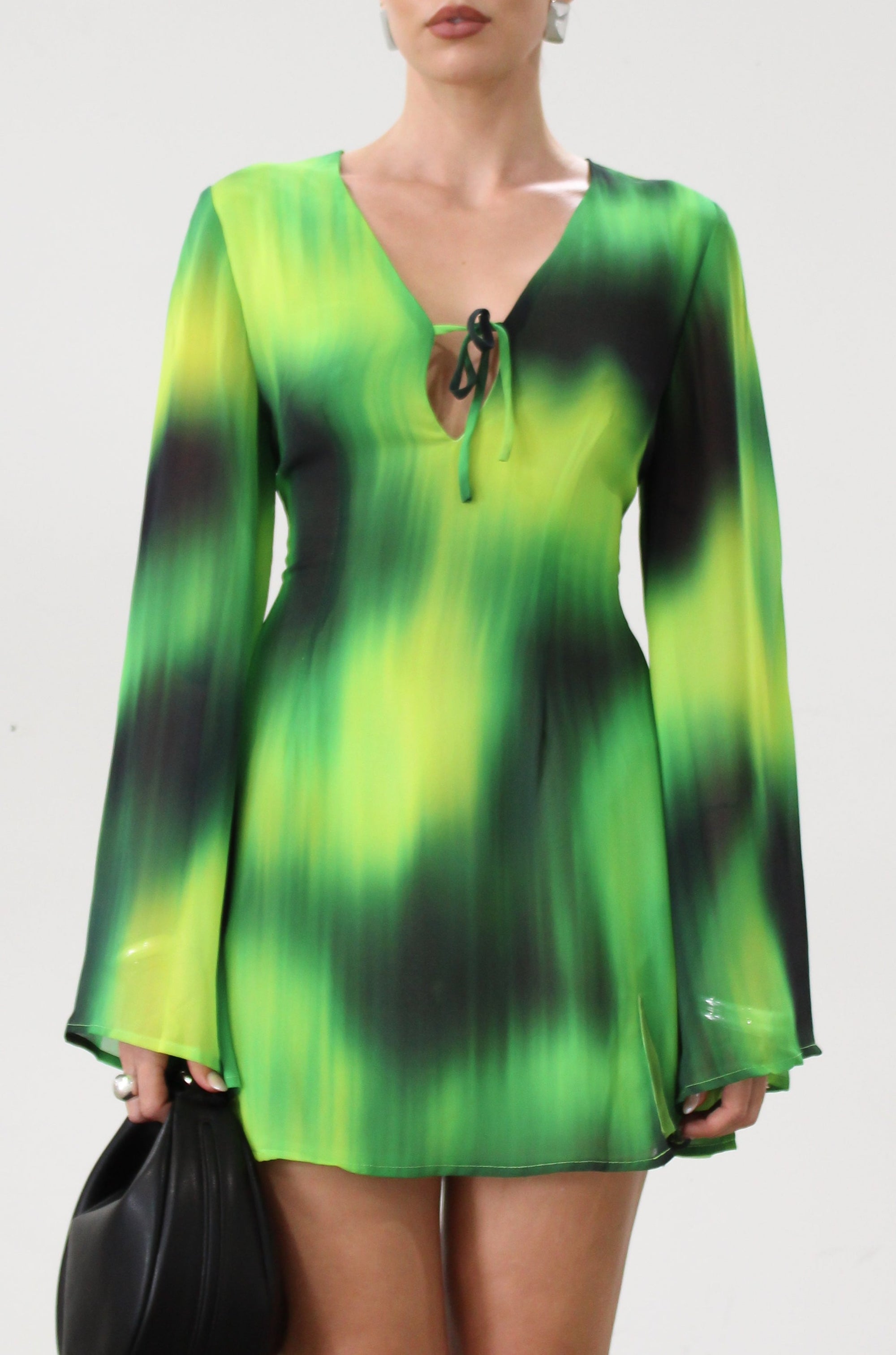 Chiffon dress. Long bell sleeves. V-neckline with tie closure. Front slit. Back hook and eye and zipper closures. Partially lined. green dress. beach vacation dress. green mini dress. mexico dress. miami dress. going out dress