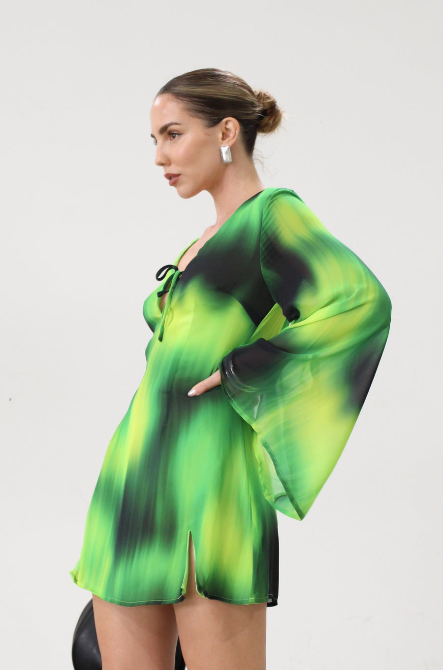 Chiffon dress. Long bell sleeves. V-neckline with tie closure. Front slit. Back hook and eye and zipper closures. Partially lined. green dress. beach vacation dress. green mini dress. mexico dress. miami dress. going out dress