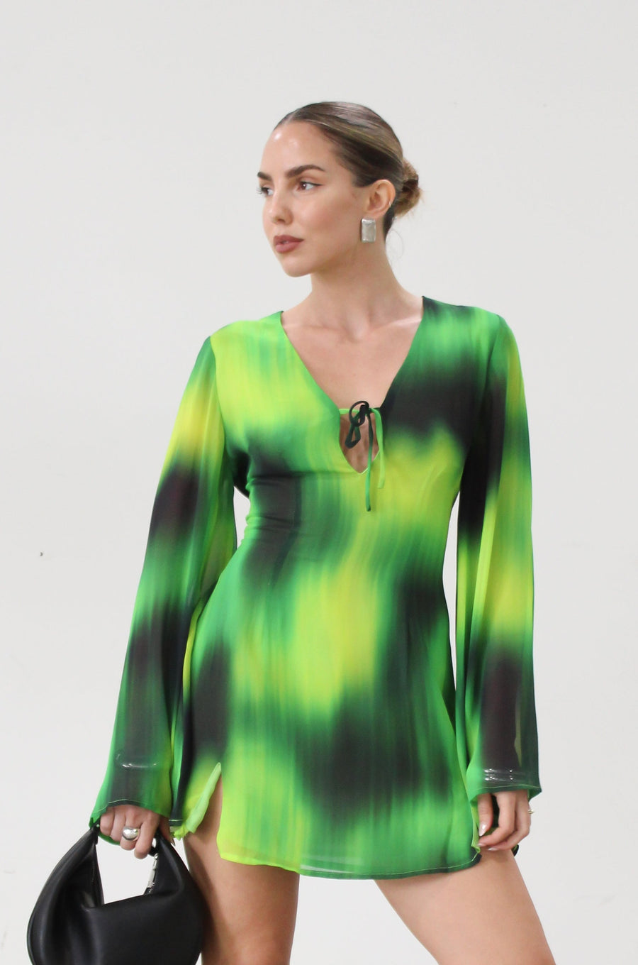 Chiffon dress. Long bell sleeves. V-neckline with tie closure. Front slit. Back hook and eye and zipper closures. Partially lined. green dress. beach vacation dress. green mini dress. mexico dress. miami dress. going out dress