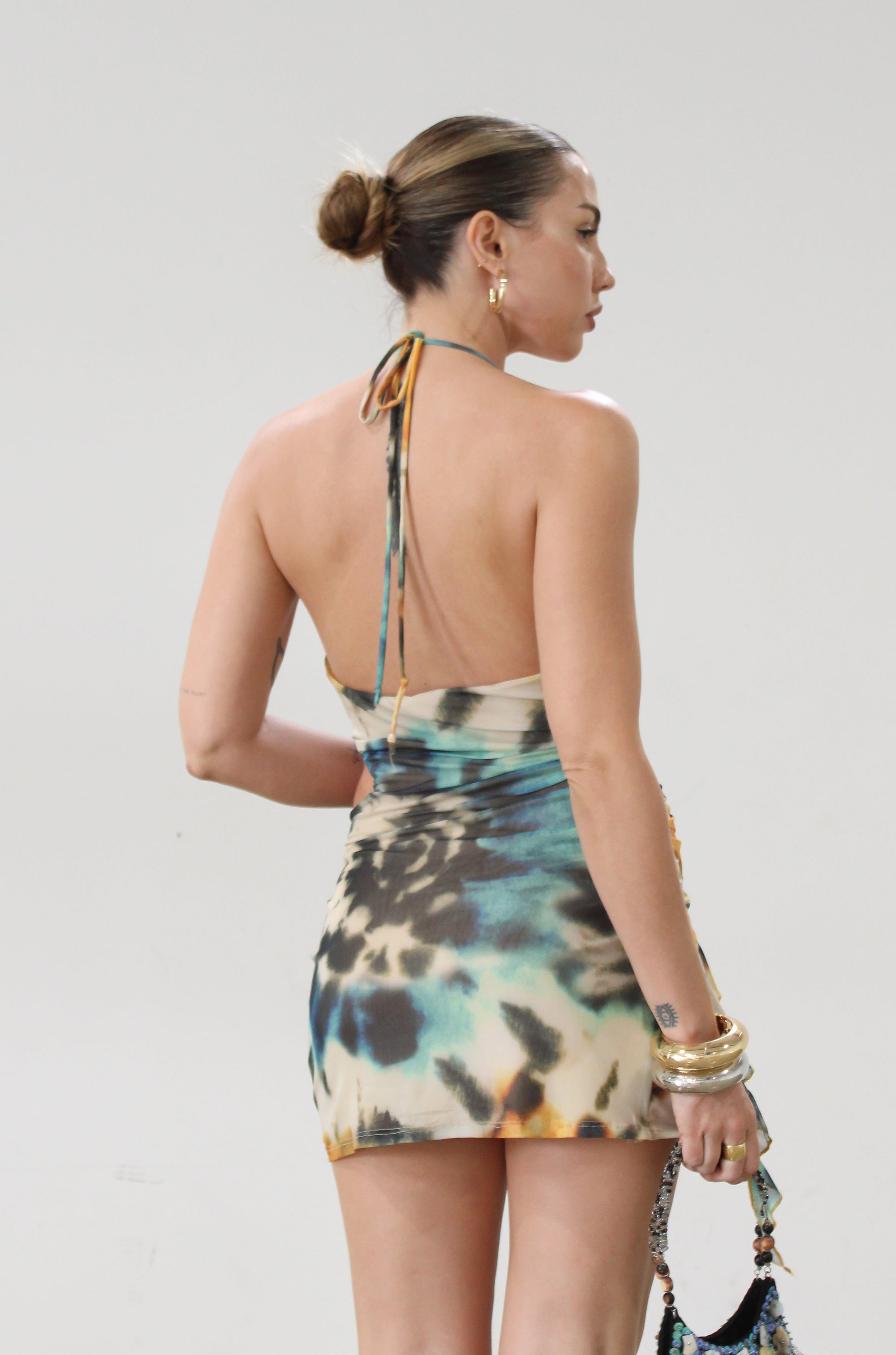 Knit mesh dress. Adjustable halter tie neck. Elastic waist. Ring detail. Side slit. Fully lined. Sexy mini dress. Tie dye mini dress. Dress with cutout. Miami dress. mexico dress. dresses to wear out