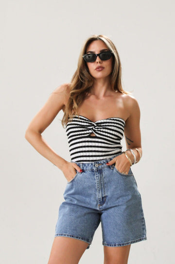 Striped crochet knit tube top. Strapless neckline. Front knot detail. Unlined. Black and white stripe
