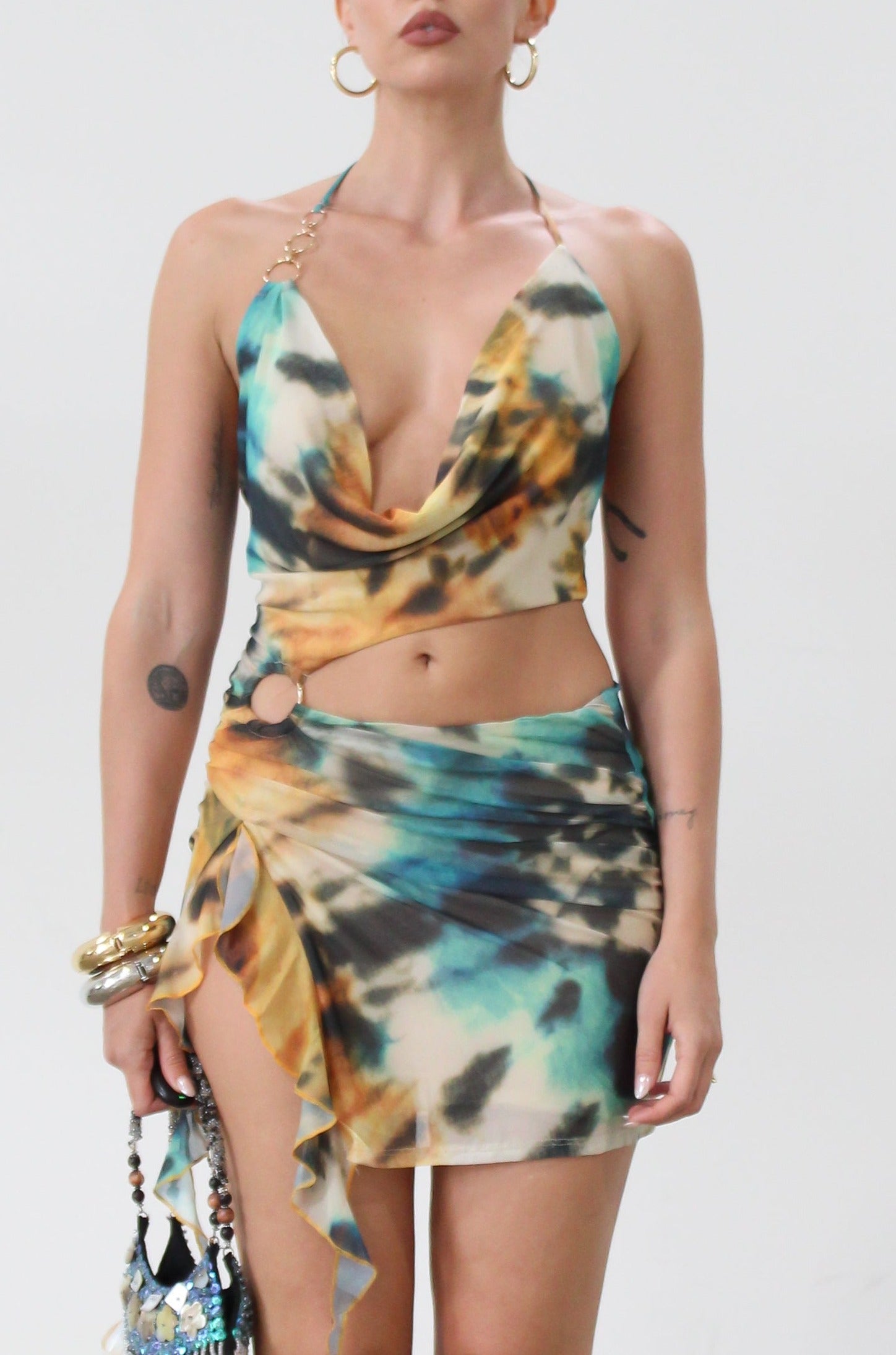 Knit mesh dress. Adjustable halter tie neck. Elastic waist. Ring detail. Side slit. Fully lined. Sexy mini dress. Tie dye mini dress. Dress with cutout. Miami dress. mexico dress. dresses to wear out