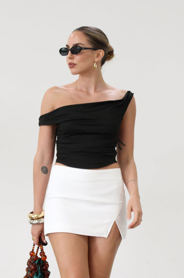 Knit crop top. Elastic straps. Ruched sides. Fully lined.. basic black top. going out top. black going out top. asymmetrical top. off the shoulder top