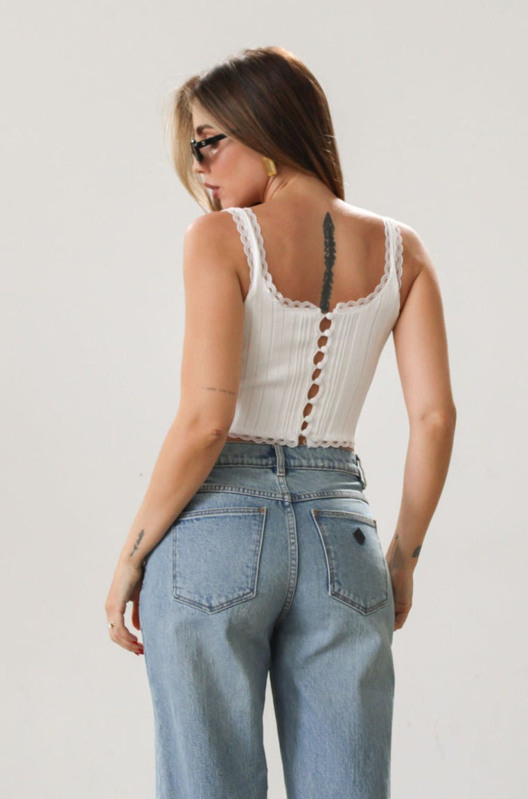 Knit crop tank. Fixed straps. Lace trim. Front tie detail. Back button down closures. Unlined. White tank top. Summer top.