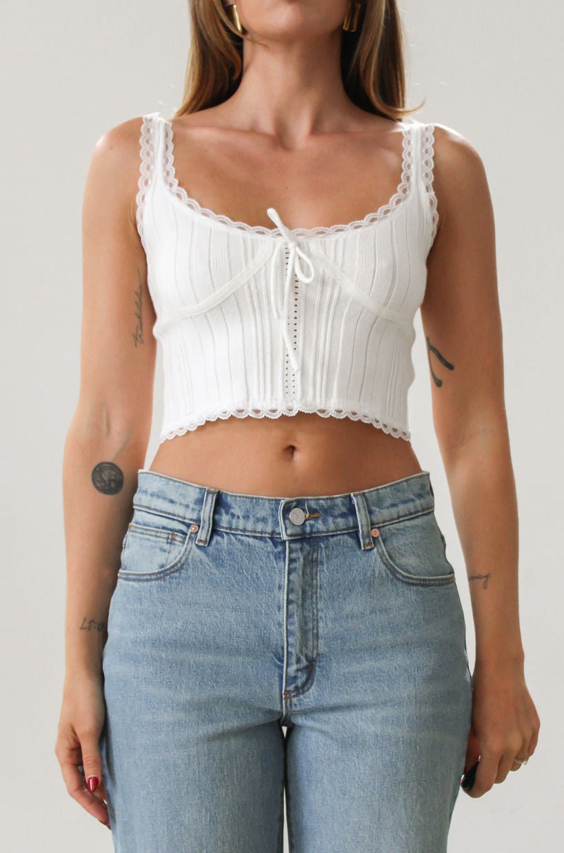 Knit crop tank. Fixed straps. Lace trim. Front tie detail. Back button down closures. Unlined. White tank top. Summer top.