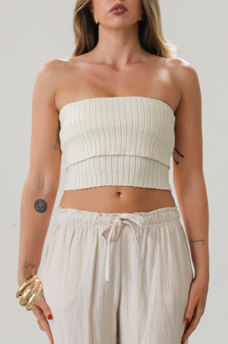 Ribbed knit tube top. Foldover elastic strapless neckline. Inner rubber grip lining. Unlined. Tube top. Ivory tube top. White tube top.