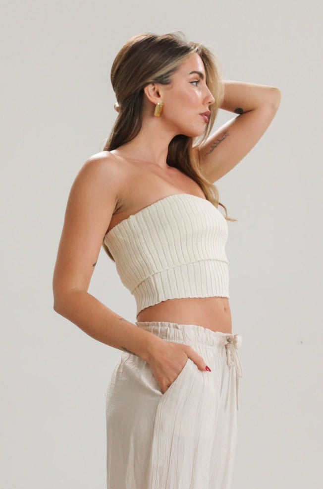 Ribbed knit tube top. Foldover elastic strapless neckline. Inner rubber grip lining. Unlined. Tube top. Ivory tube top. White tube top.