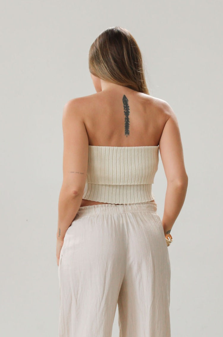 Ribbed knit tube top. Foldover elastic strapless neckline. Inner rubber grip lining. Unlined. Tube top. Ivory tube top. White tube top.