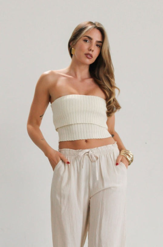 Ribbed knit tube top. Foldover elastic strapless neckline. Inner rubber grip lining. Unlined. Tube top. Ivory tube top. White tube top.