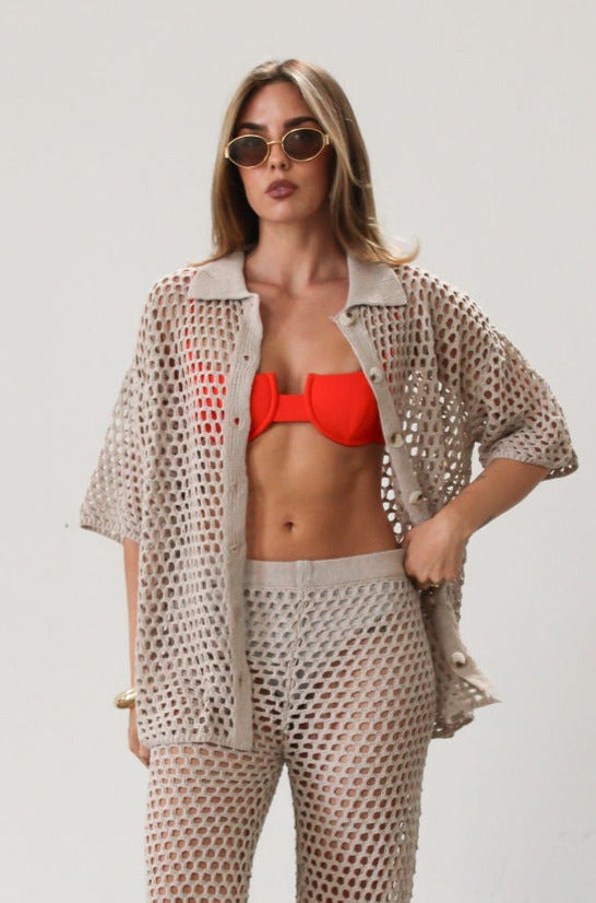Open knit crochet shirt. Collar neckline. Short sleeves. Front button down closures. Unlined/sheer. Beach coverup. Pool coverup. Tan oat top