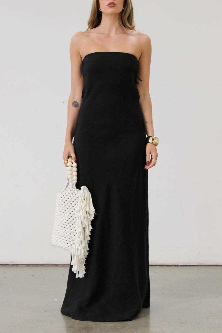 Linen woven maxi dress. Strapless neckline. Elastic back. Back zipper closure. Unlined. Black maxi dress. Black tie dress. Wedding guest dress.
