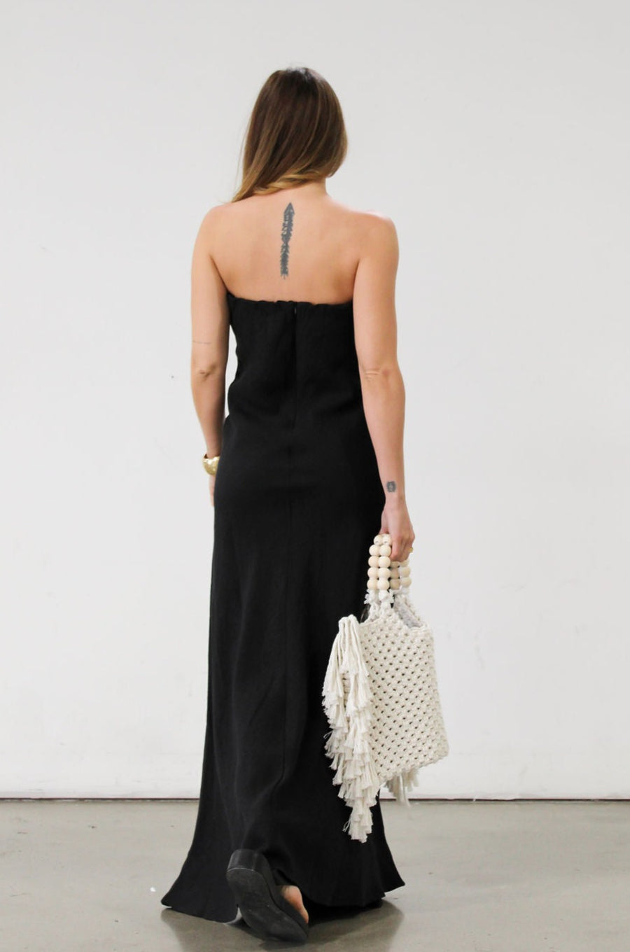 Linen woven maxi dress. Strapless neckline. Elastic back. Back zipper closure. Unlined. Black maxi dress. Black tie dress. Wedding guest dress.