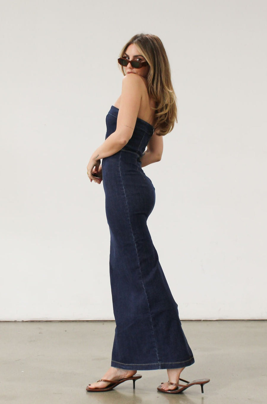 Stretch denim maxi dress. Folded strapless neckline. Back snap button and zipper closures. Back slit. Unlined. Brunch outfit. Summer maxi dress