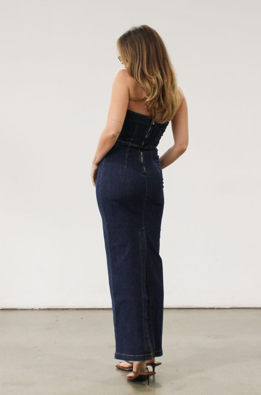 Stretch denim maxi dress. Folded strapless neckline. Back snap button and zipper closures. Back slit. Unlined. Brunch outfit. Summer maxi dress