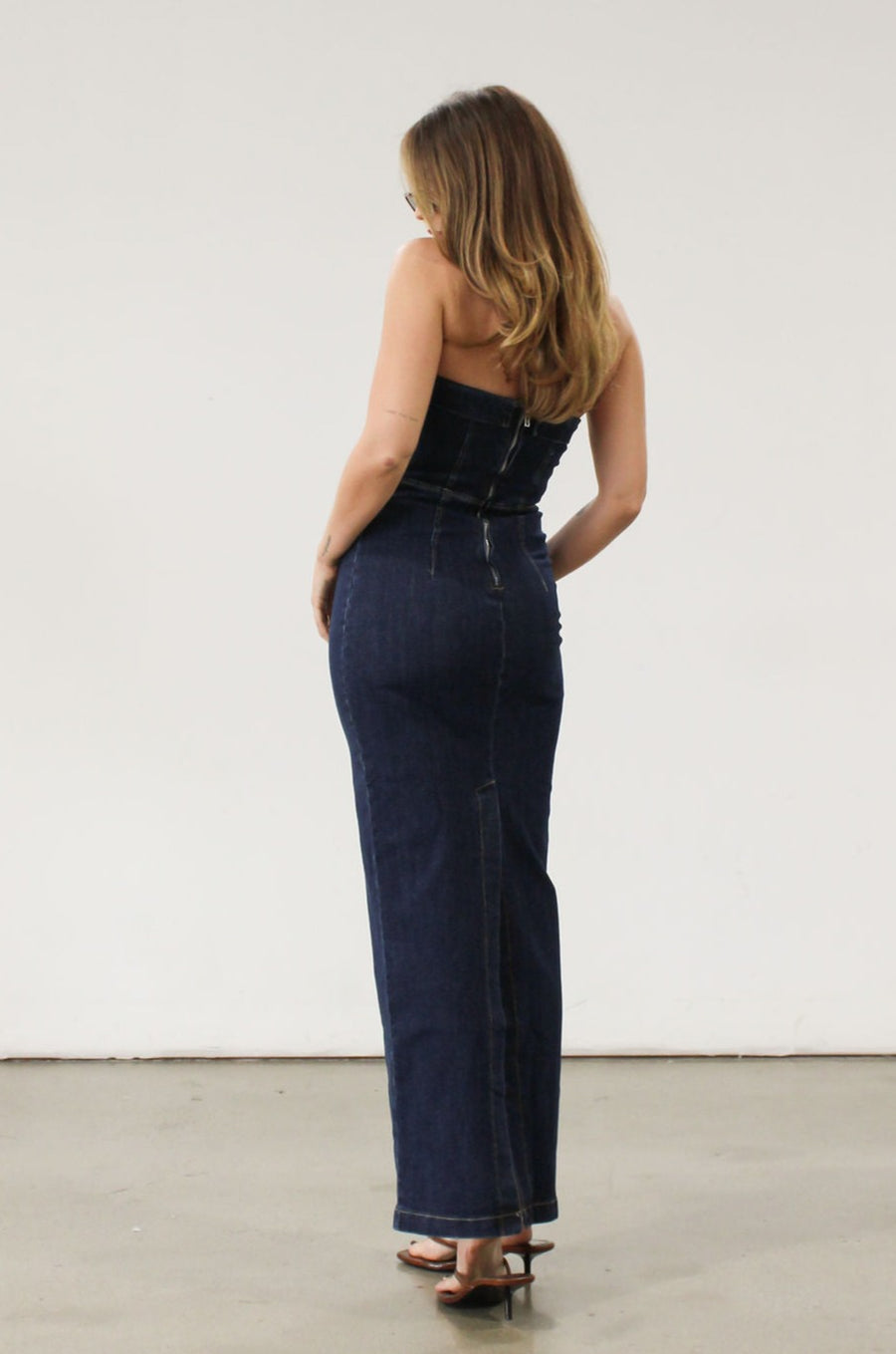 Stretch denim maxi dress. Folded strapless neckline. Back snap button and zipper closures. Back slit. Unlined. Brunch outfit. Summer maxi dress