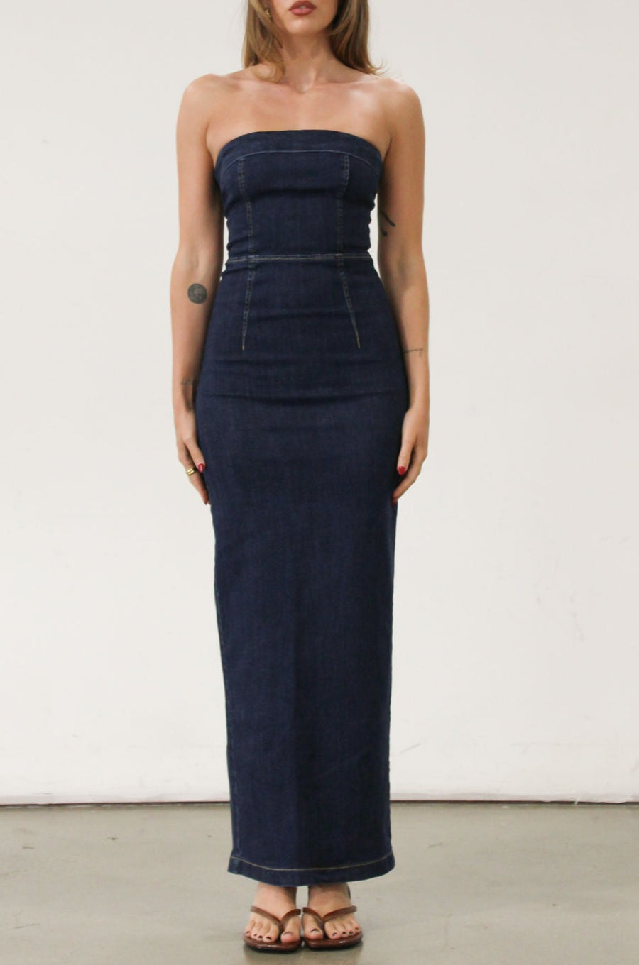 Stretch denim maxi dress. Folded strapless neckline. Back snap button and zipper closures. Back slit. Unlined. Brunch outfit. Summer maxi dress
