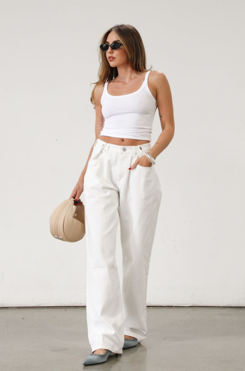 Wide leg jeans. Adjustable button waist closures. Button and zipper fly. Four pocket construction. Unlined. White jeans. White baggy jeans