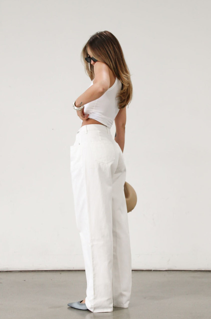 Wide leg jeans. Adjustable button waist closures. Button and zipper fly. Four pocket construction. Unlined. White jeans. White baggy jeans