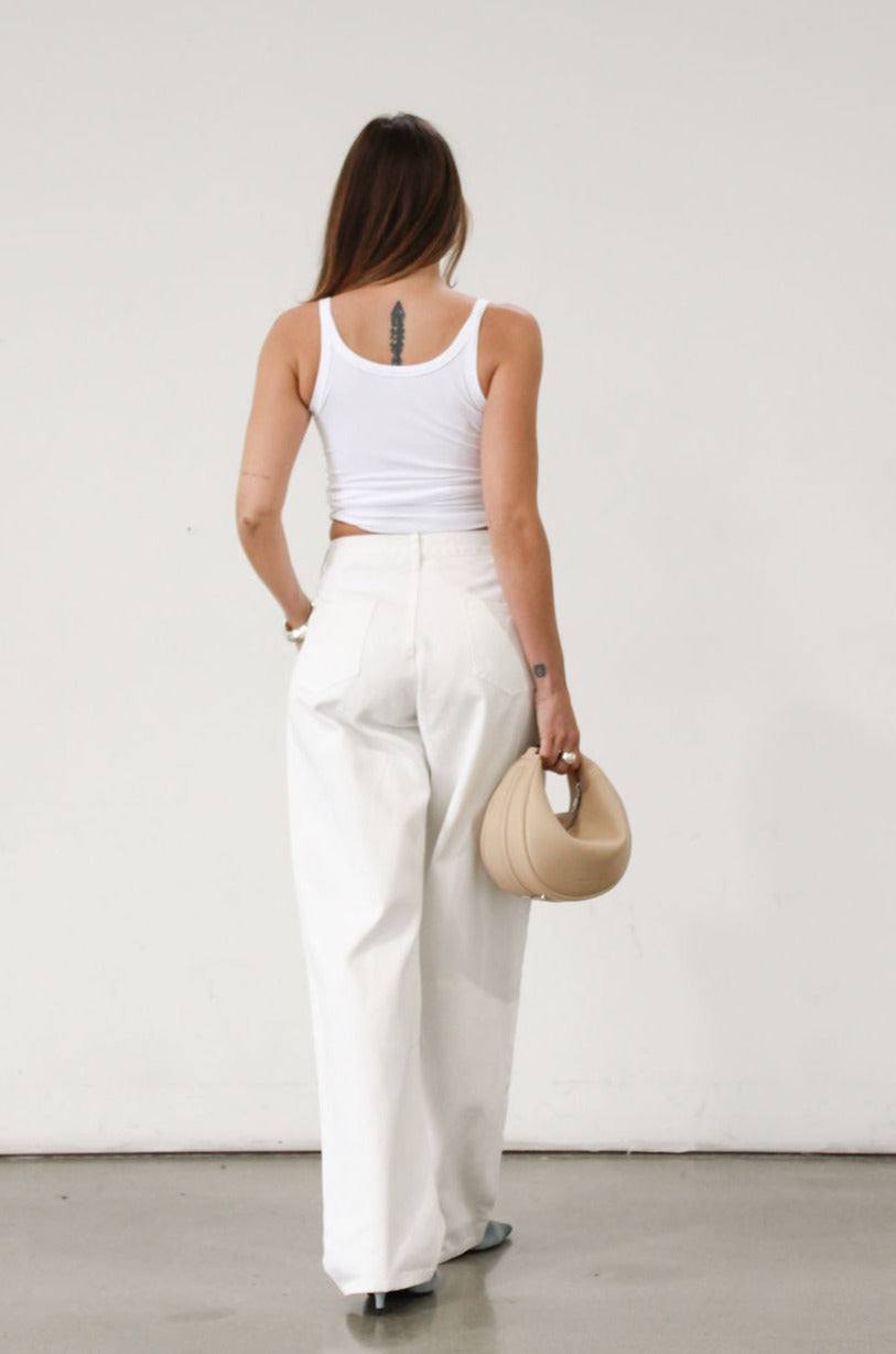 Wide leg jeans. Adjustable button waist closures. Button and zipper fly. Four pocket construction. Unlined. White jeans. White baggy jeans